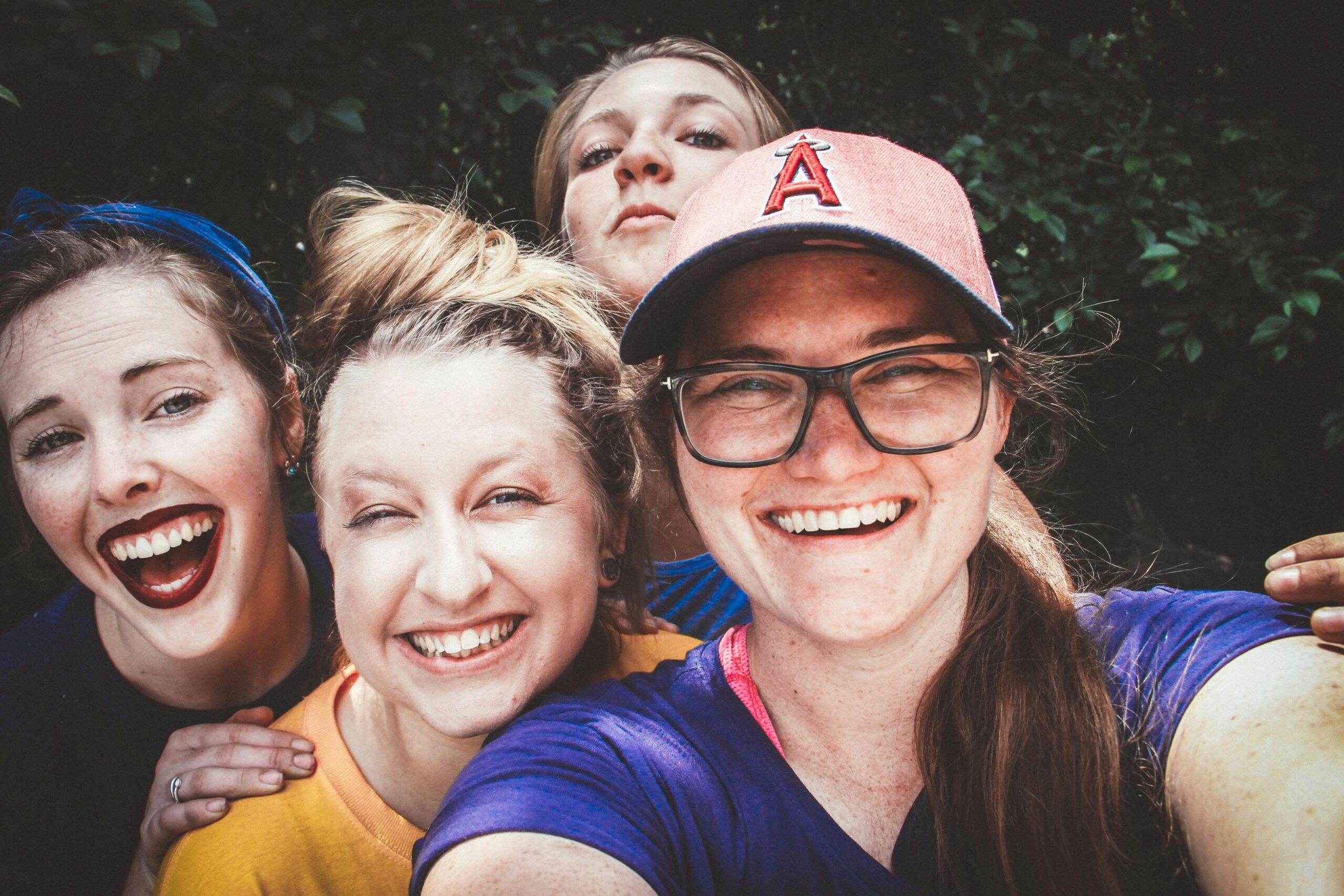 Guest Management A joyful group of women taking a selfie outdoors, showcasing happiness and friendship.